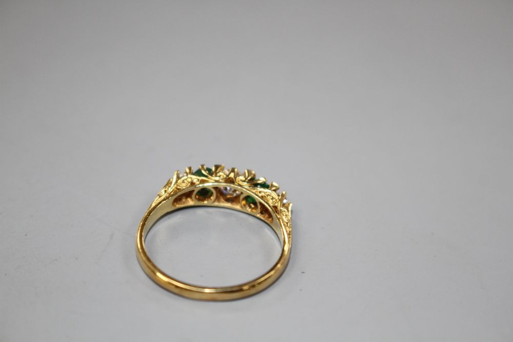 A modern Victorian style 18ct gold, two stone emerald and three stone diamond set half hoop ring,